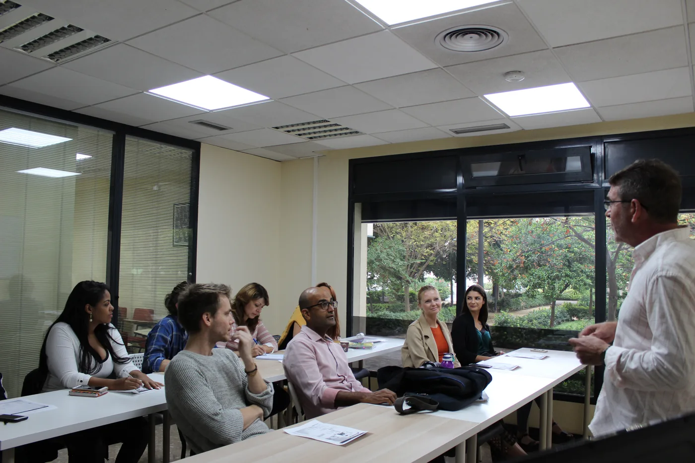 Open Spanish class with students in the bright classroom