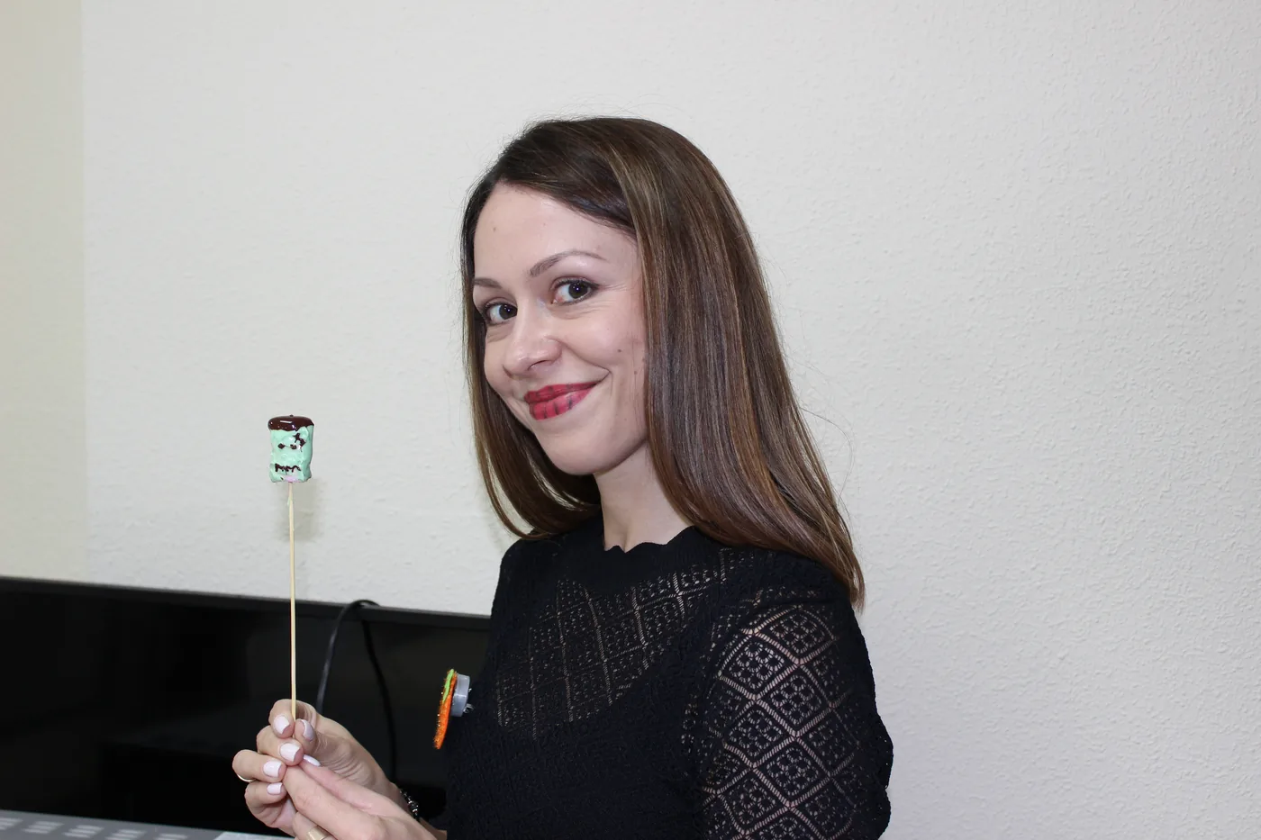 A student with a Halloween sweet in the decorated classroom