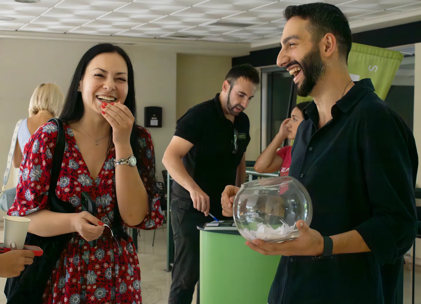 Students laughing with a teacher in the school corridor at the party