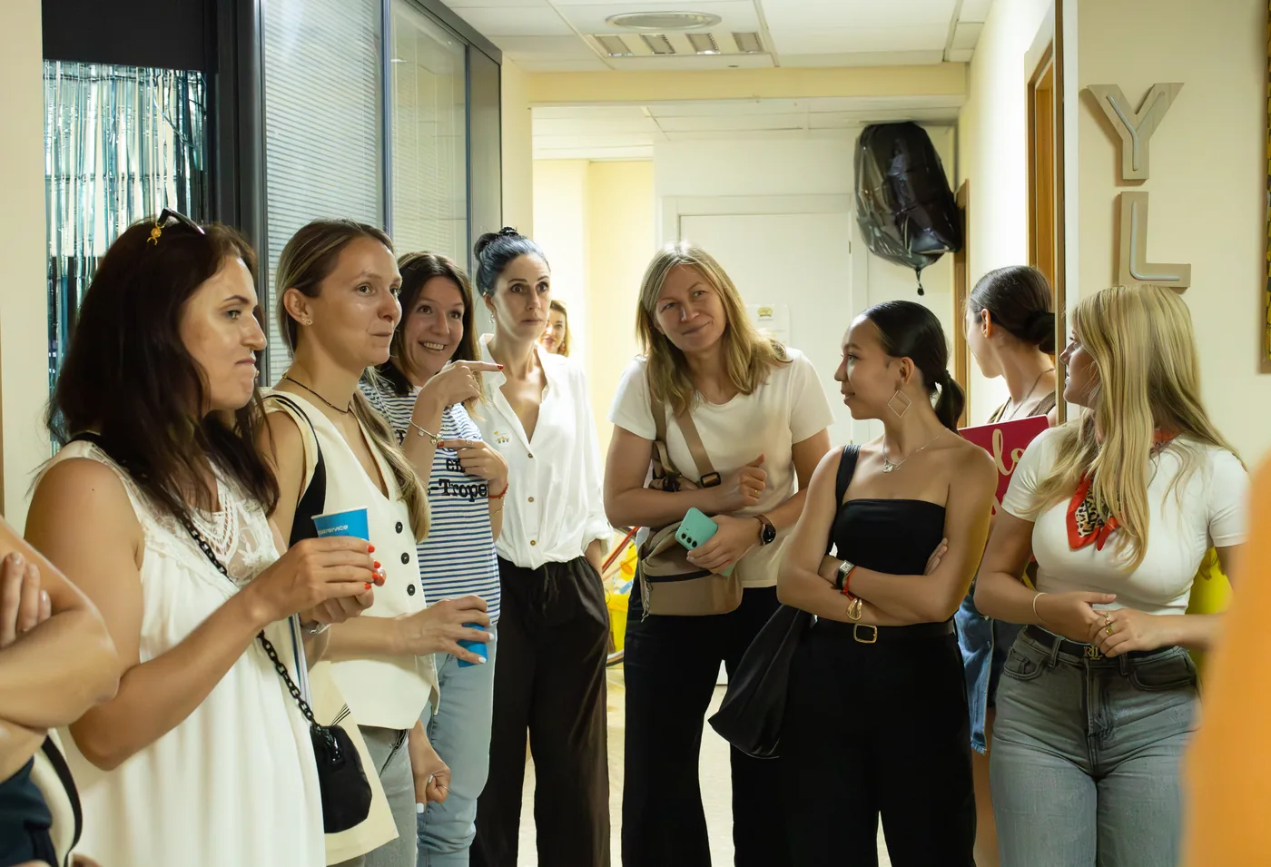 A group of students chatting in the corridor during the draw